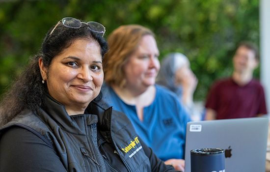 employee holding tumbler