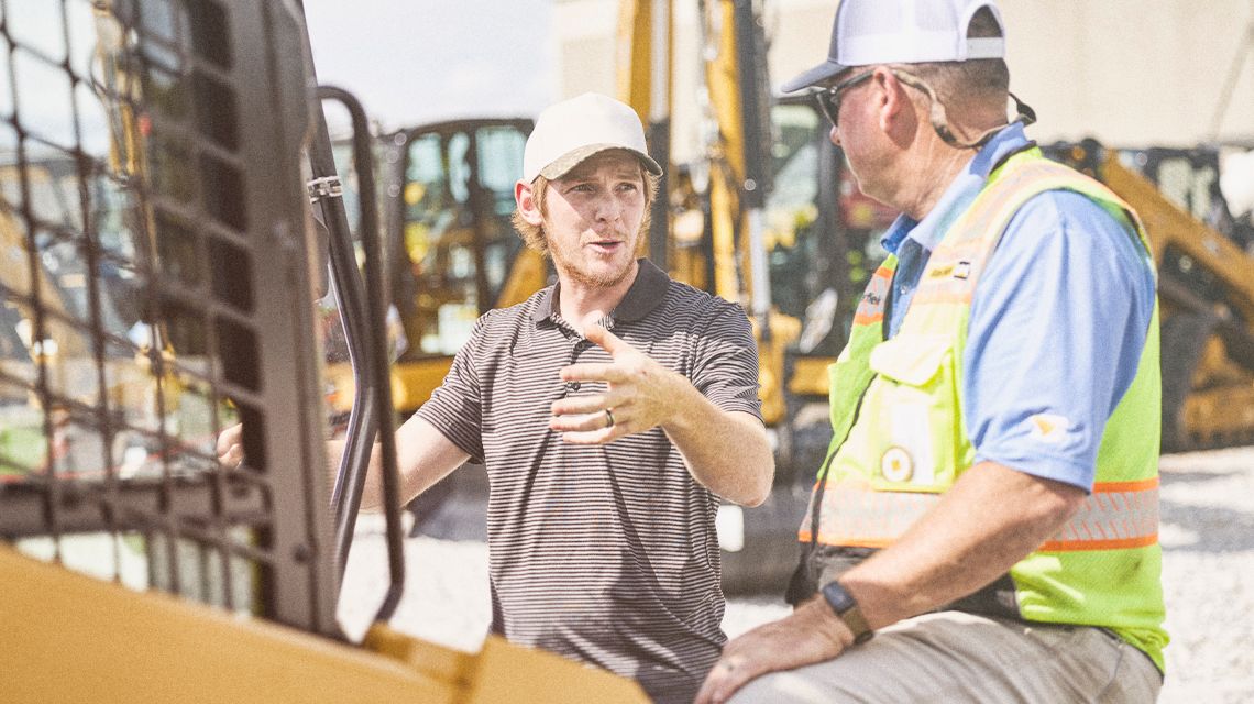 Two men in front of equipment