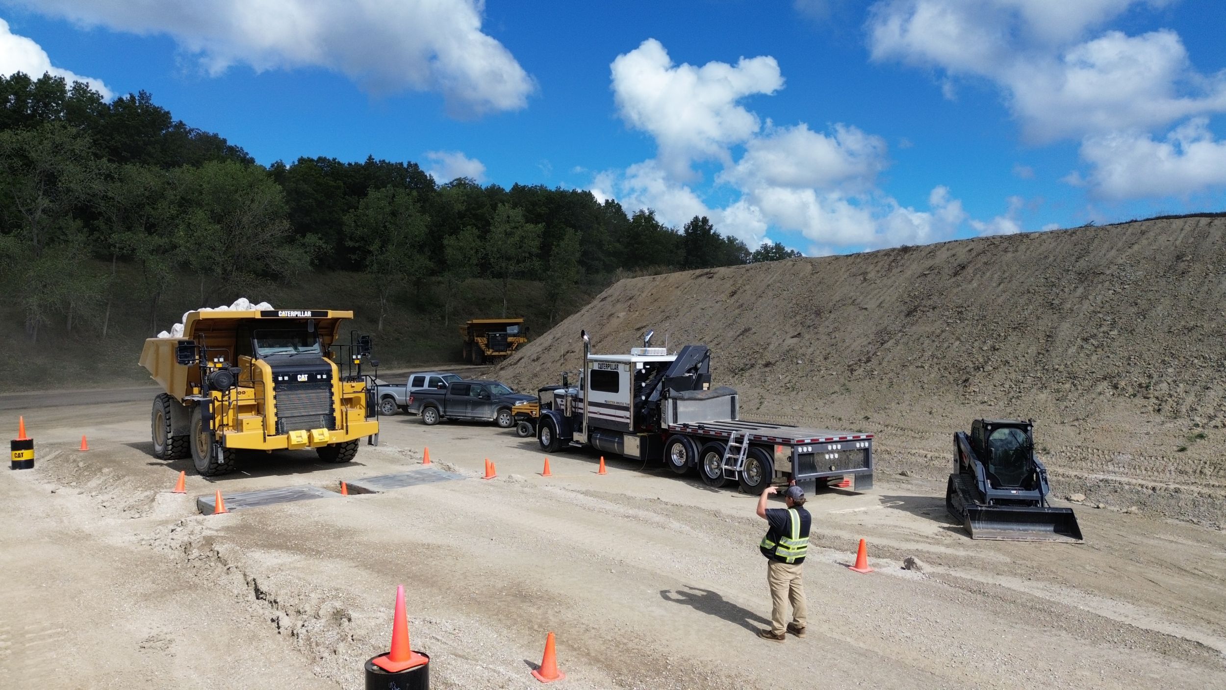 man taking picture of mining truck