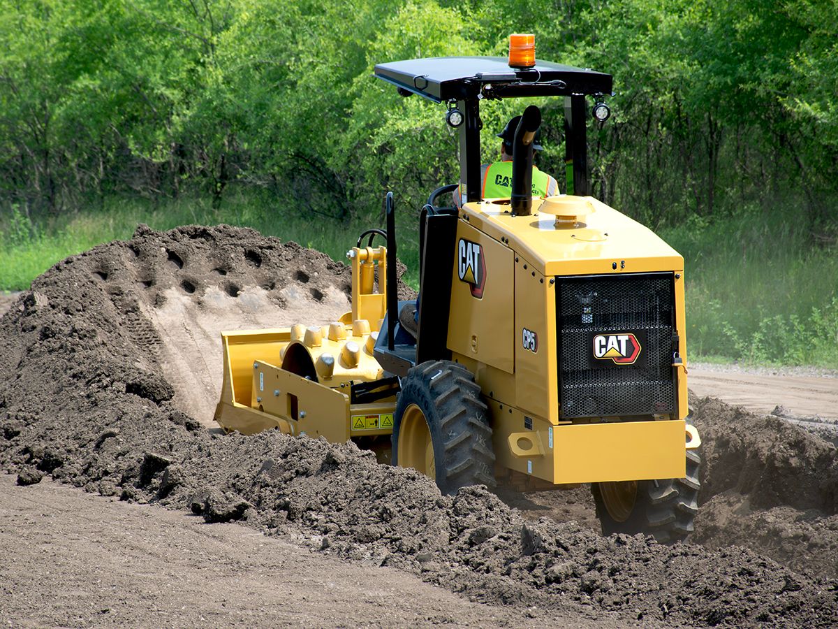 Cat CP5 vibratory soil compactor working in a trench