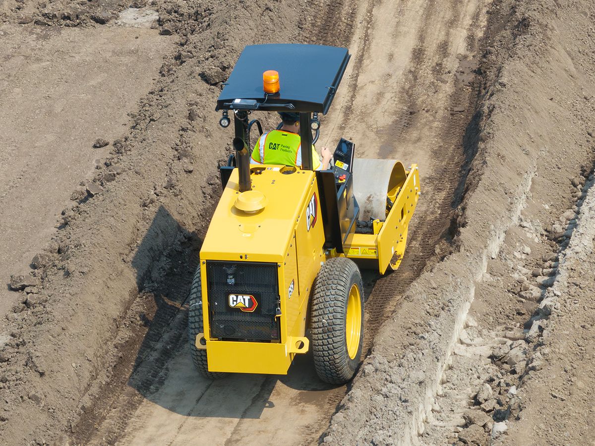 Cat CS5 vibratory soil compactor working in a trench