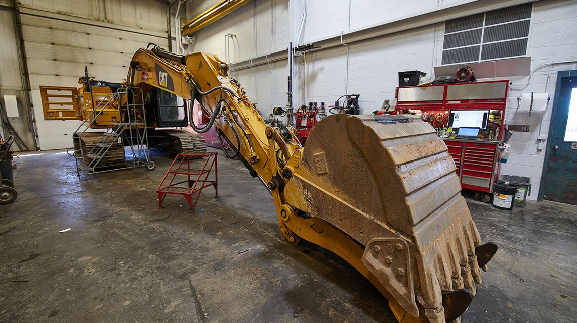 an excavator being worked on
