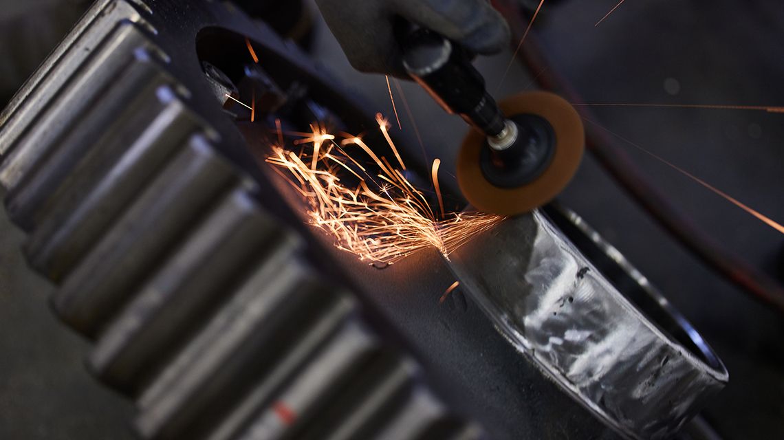 a dremel creating sparks on a gear