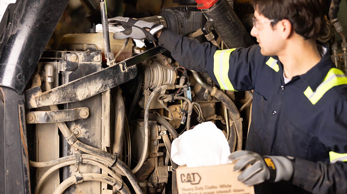 mechanic working on machine engine