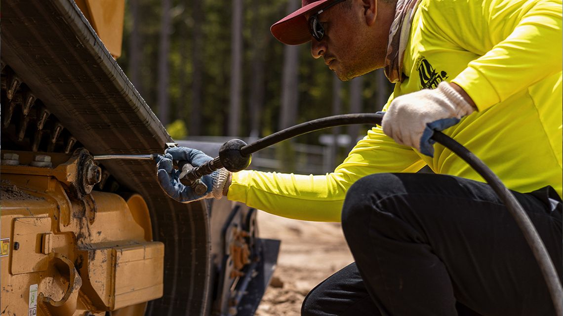 a technician oiling tracks