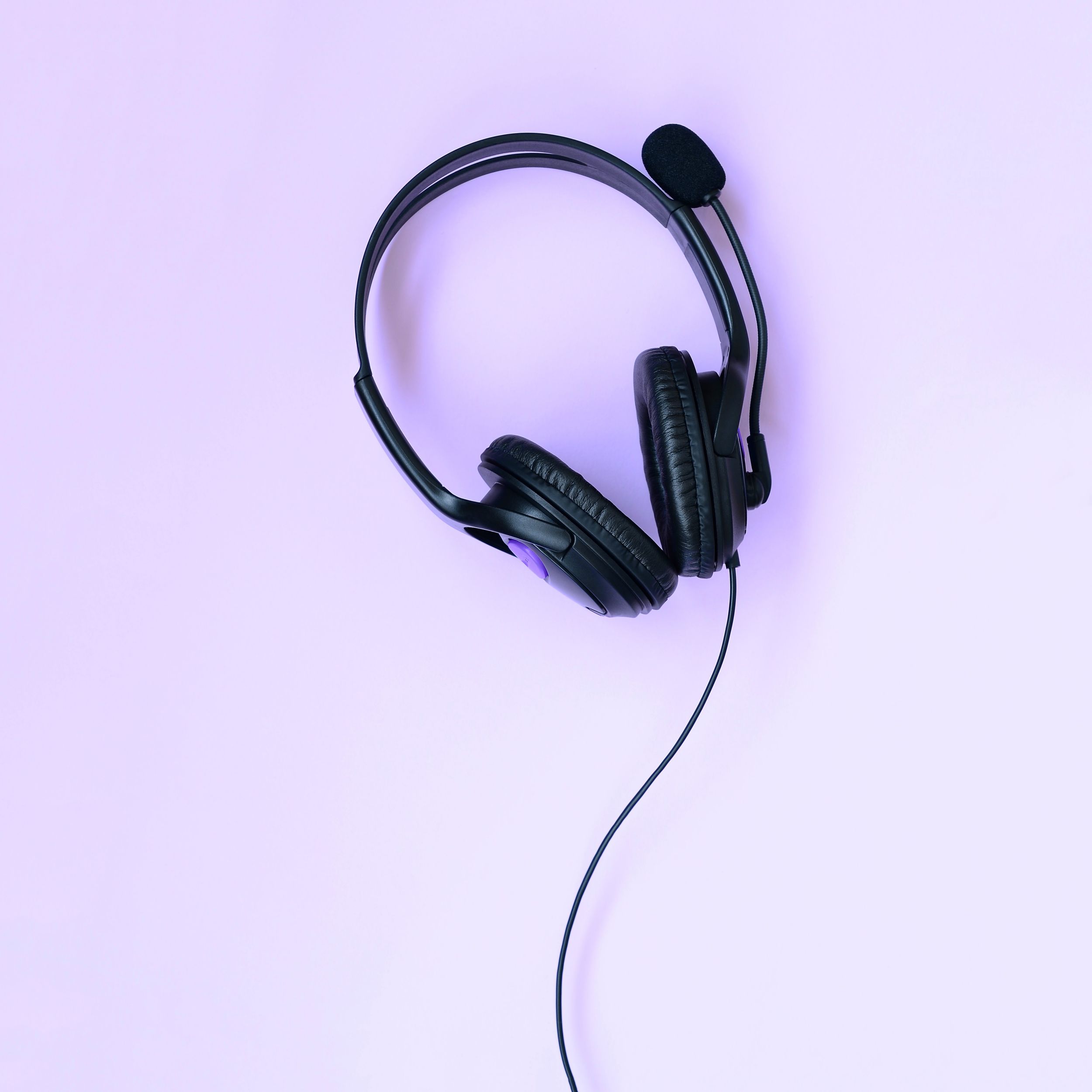 a black headset on a light purple background