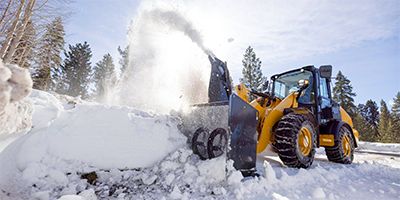 Motor grader plowing snow