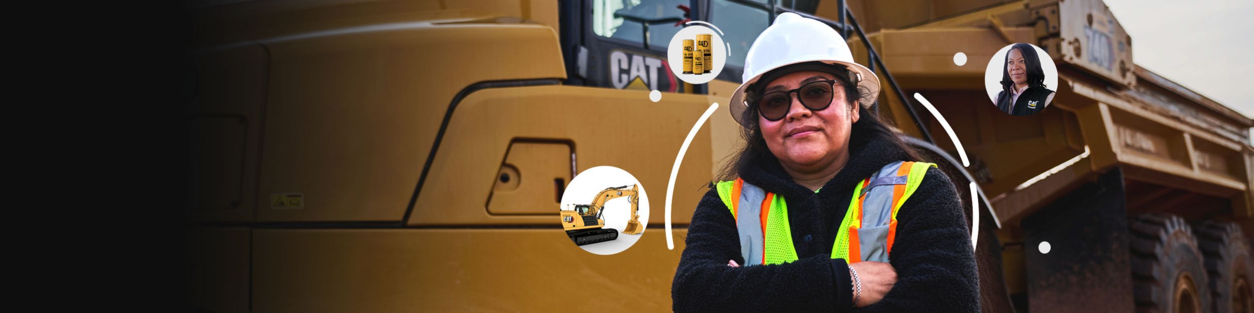 Woman standing in front of a Cat machine with bubbles with equipment, parts and a Cat representative