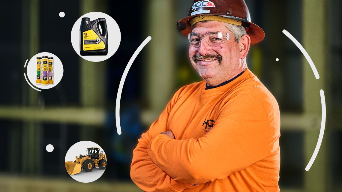 Man smiling at camera with bubbles around him with Cat parts and equipment