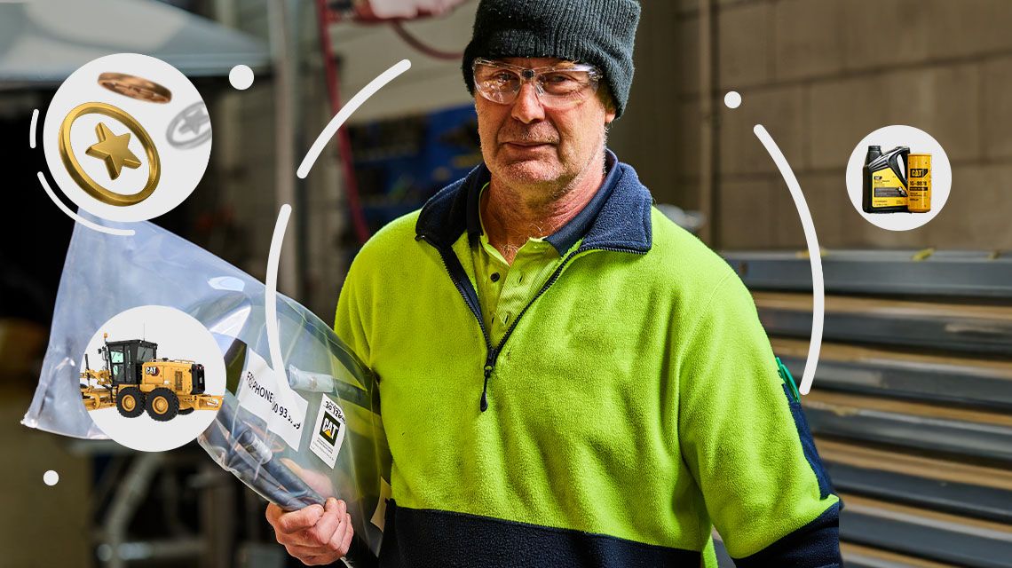 Man working with bubbles around him with Cat parts and equipment