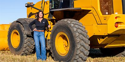 Caterpillar dealer posing in front of equipment