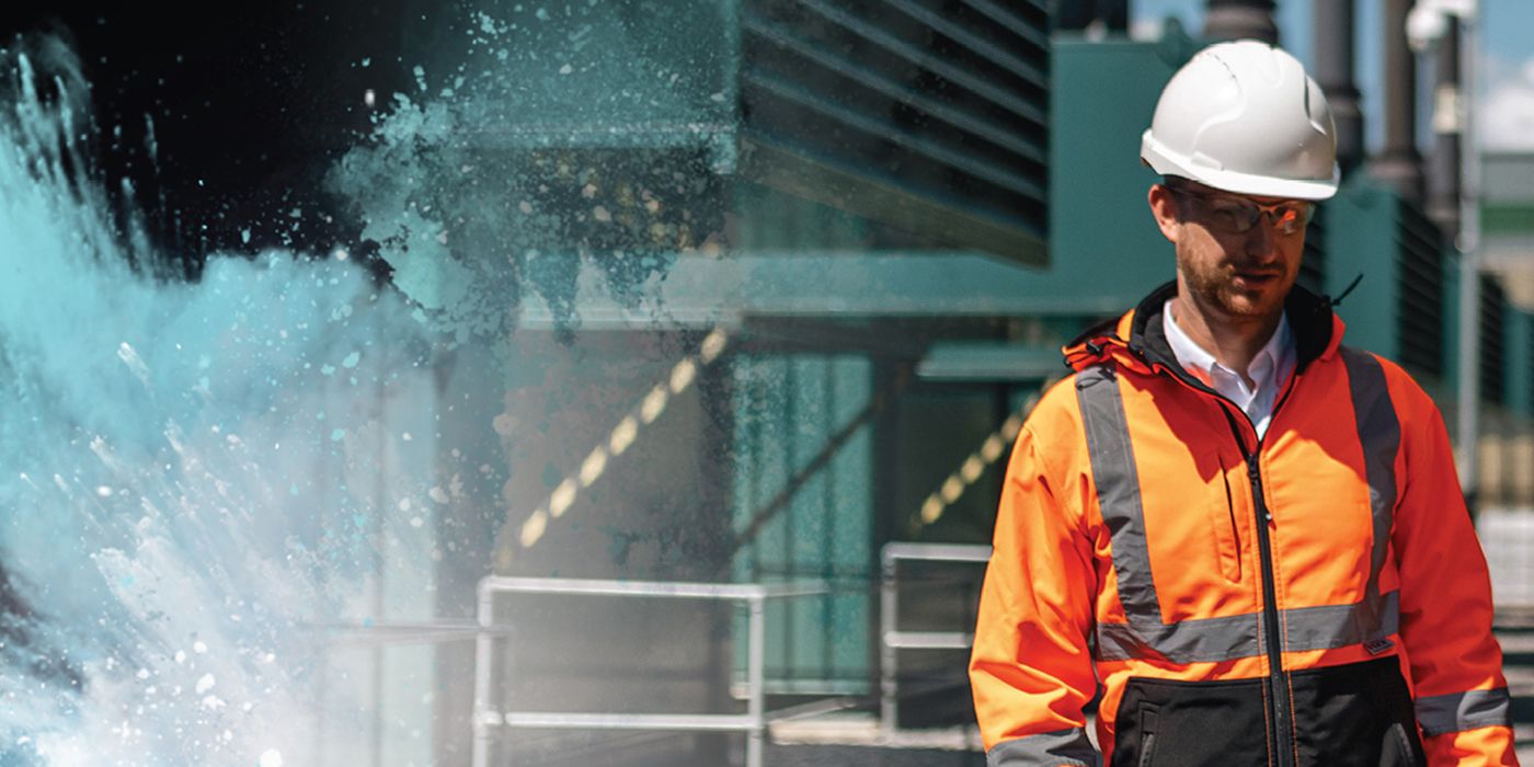 Industrial worker standing outside in front of a facility