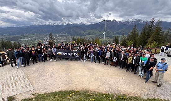 Large group of employees with sign