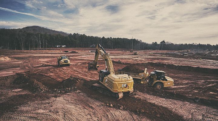 Cat machines operating on open work site