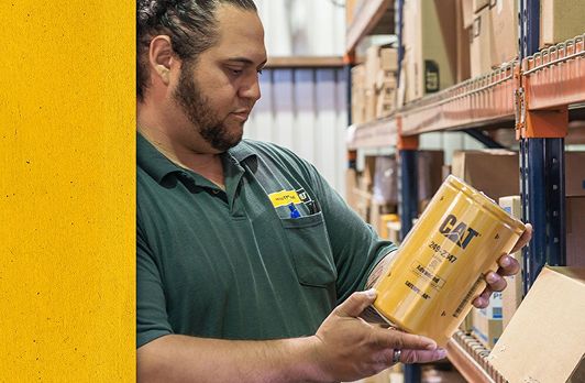 Cat employee in warehouse holding up a product
