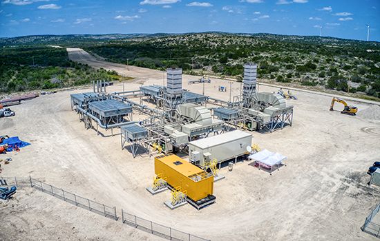 Solar Turbines Titan 250 units in operation at an open ground modular compression site, driving natural gas movement through pipelines across Texas.