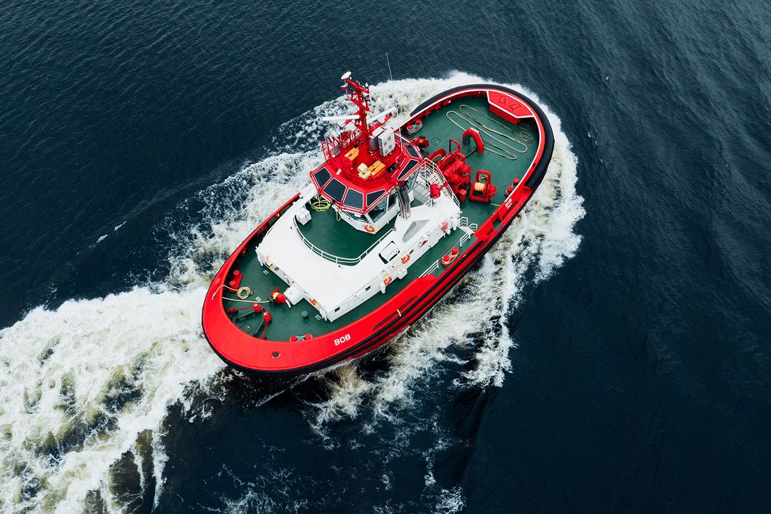 Red boat cruising in a body of water