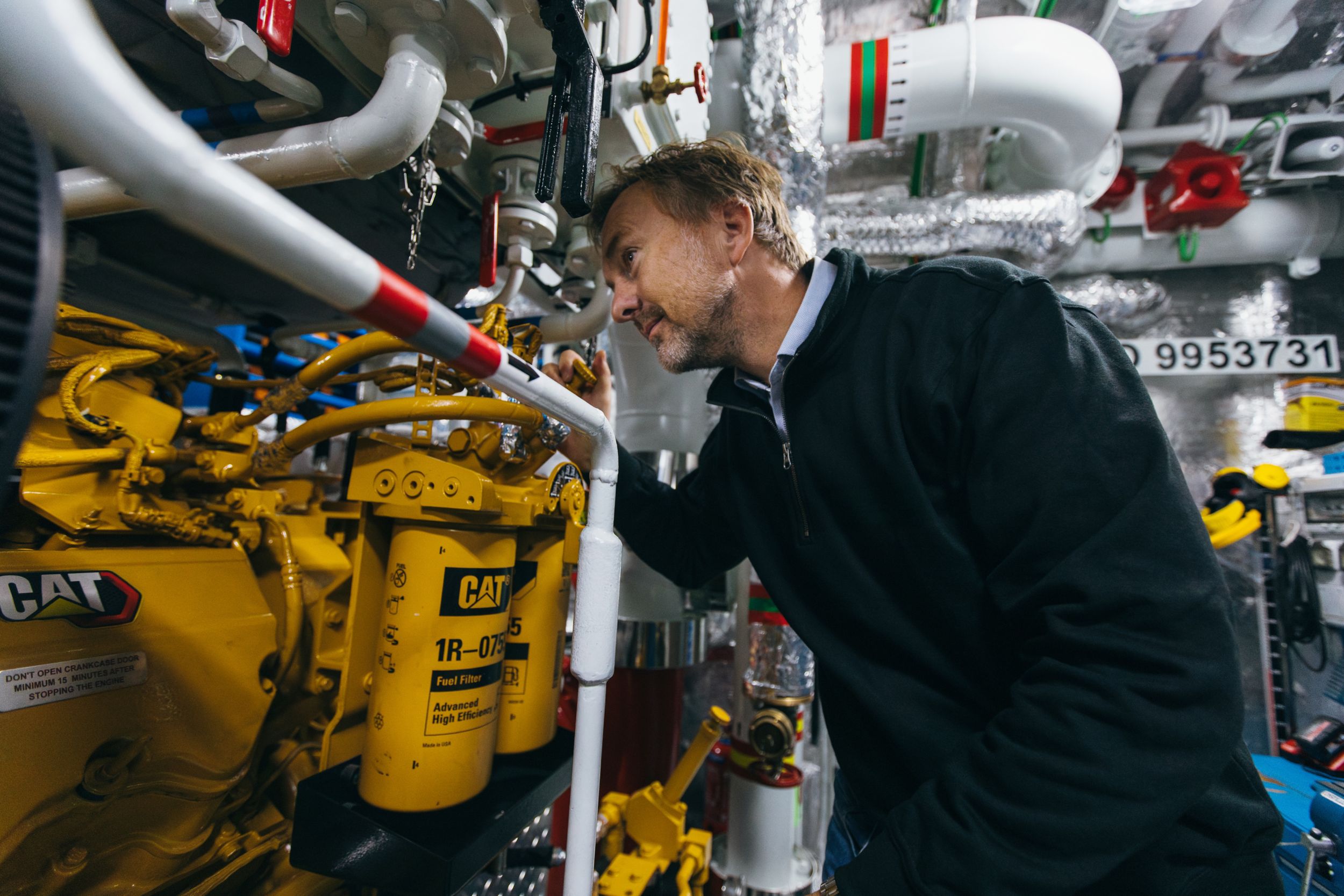 Technician inspecting a marine engine