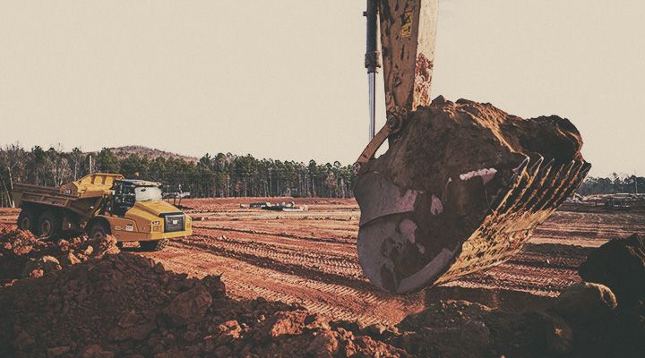 Cat excavator claw close up picking up dirt