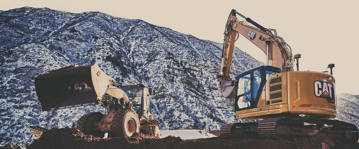 Cat excavator next to Cat wheel loader