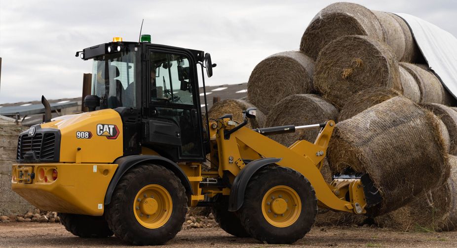 Small Wheel loader hauling haybales