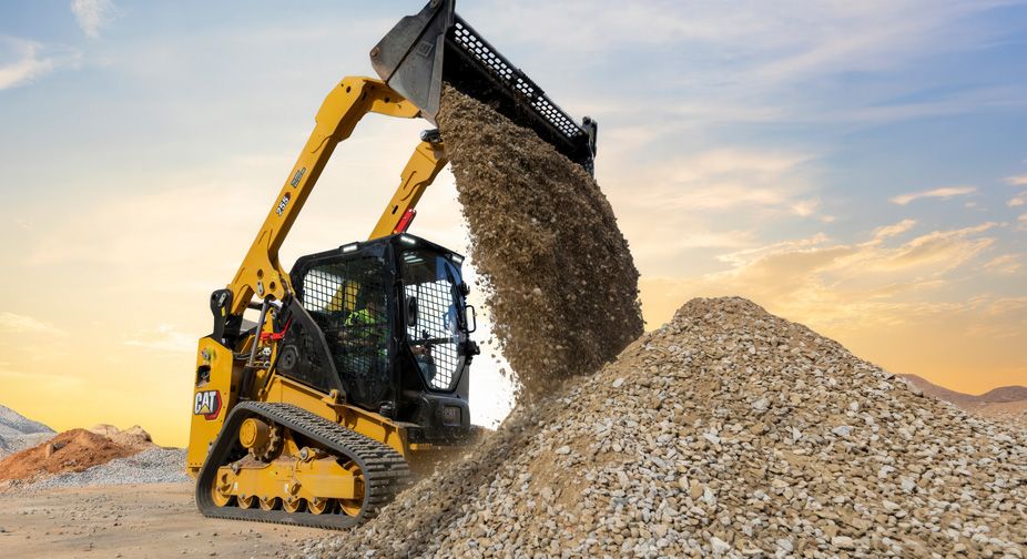 Compact Track loader dumping gravel