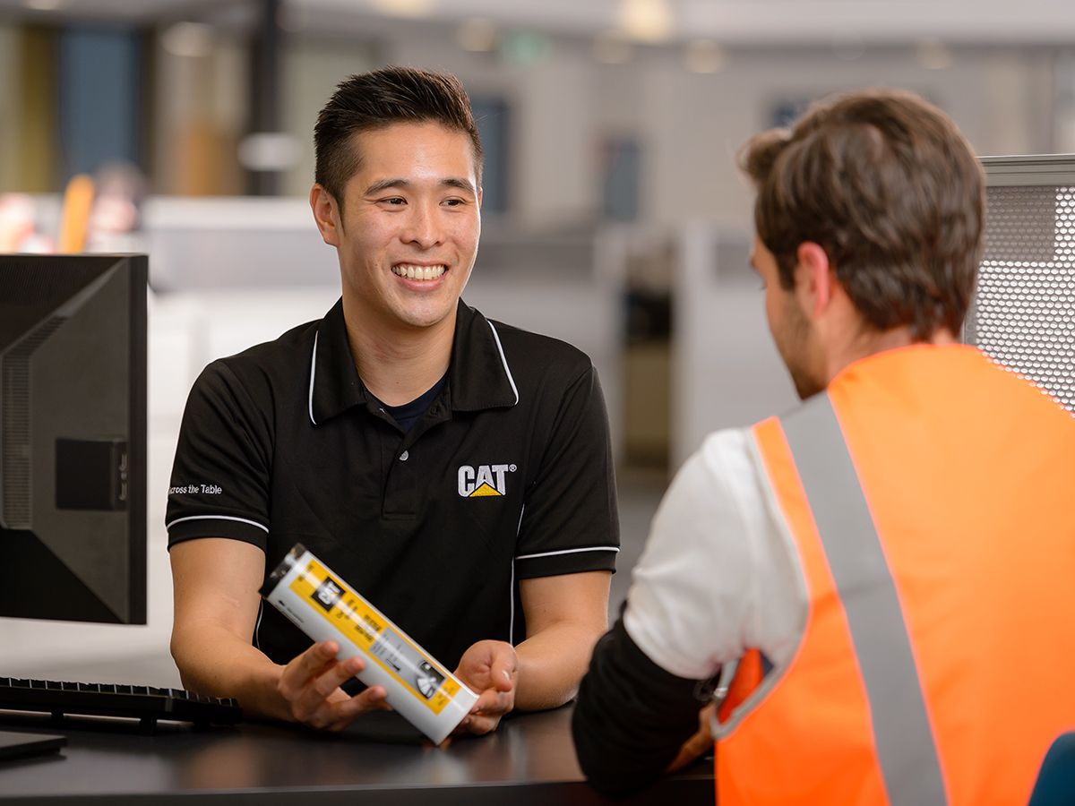 Cat parts counter, Cat dealer selling a filter to a customer
