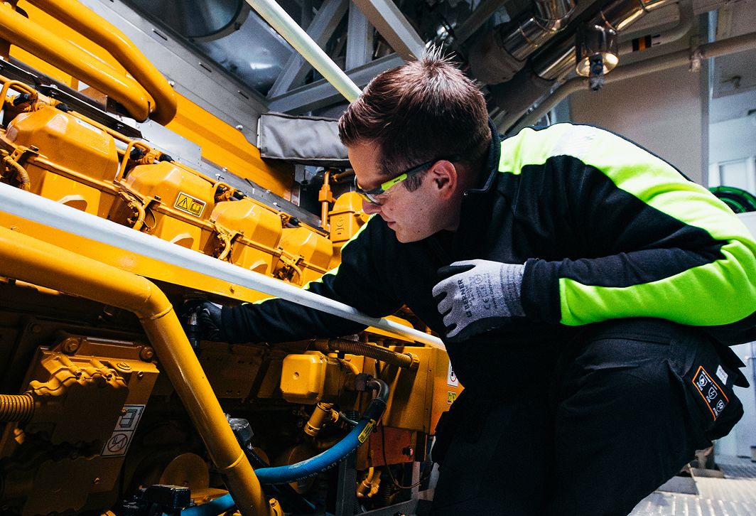 Image inside of a vessel of of a man working on Cat equipment