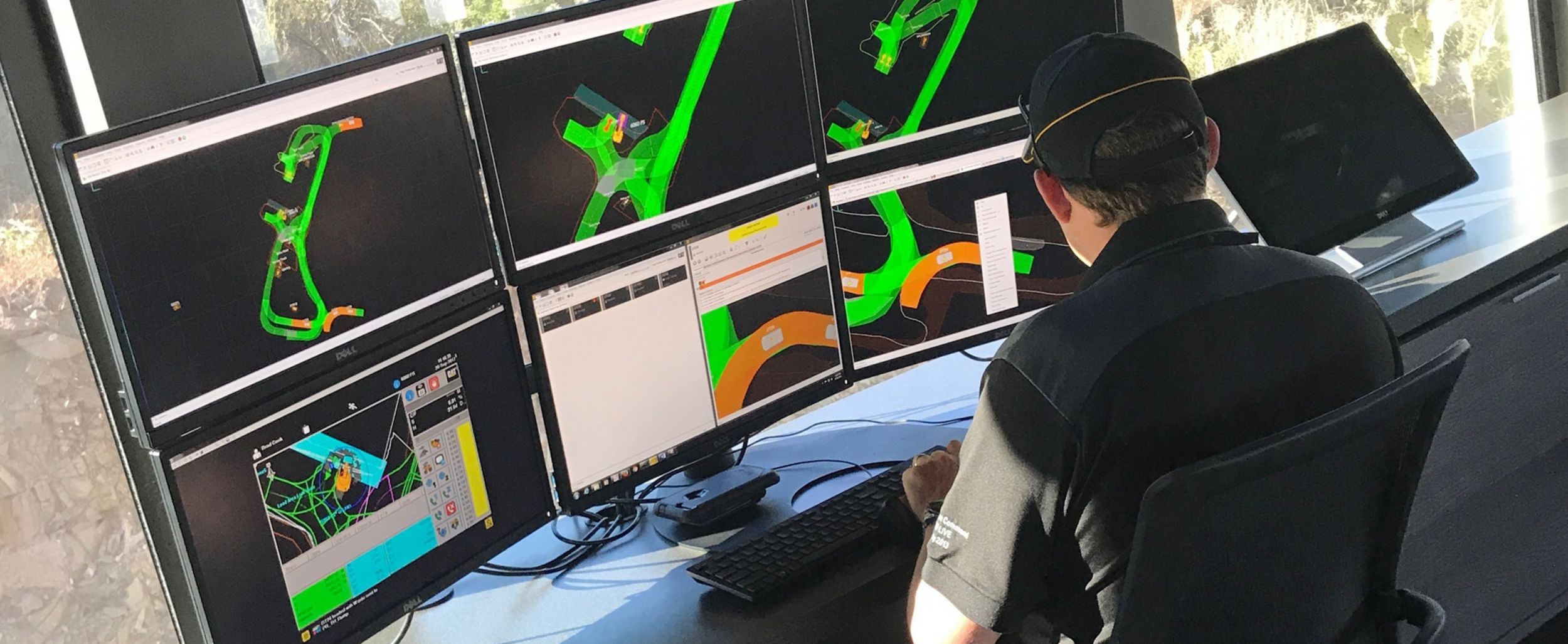 Man looking at multiple monitors