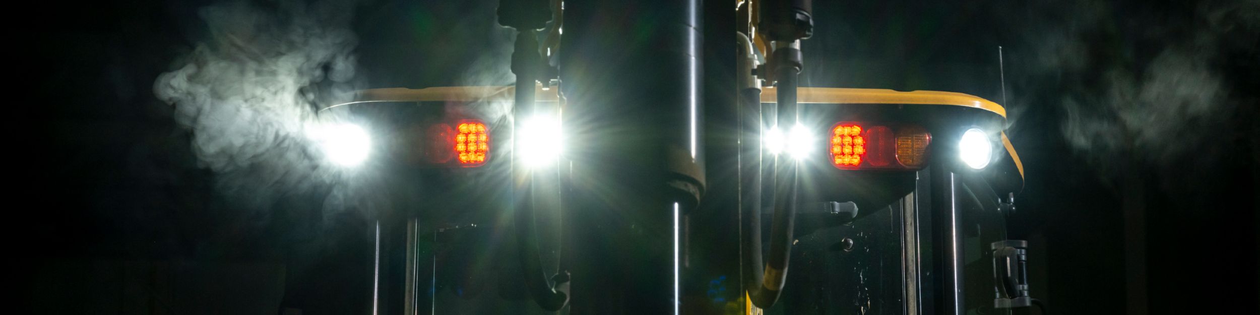 Nighttime photo of floodlights on Cat equipment