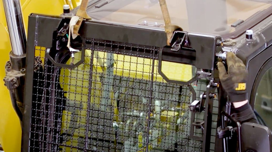 Installing safety grate on Cat equipment