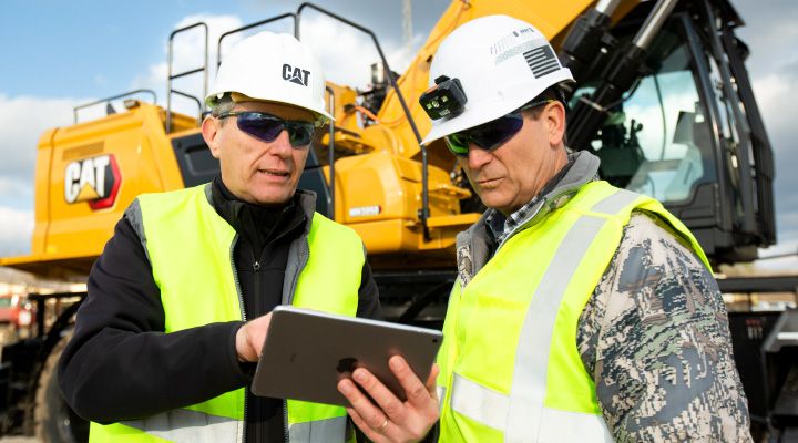 construction professionals reviewing the contents of a tablet