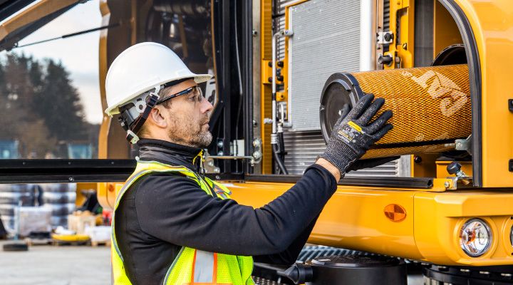a construction professional inspecting a machine