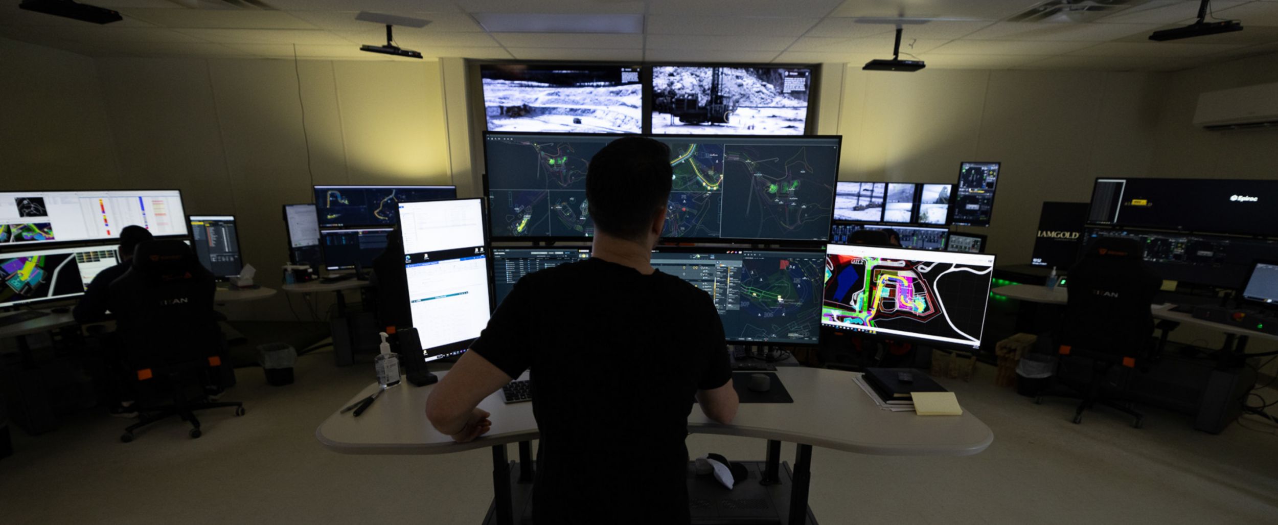 Man looking at multiple monitors