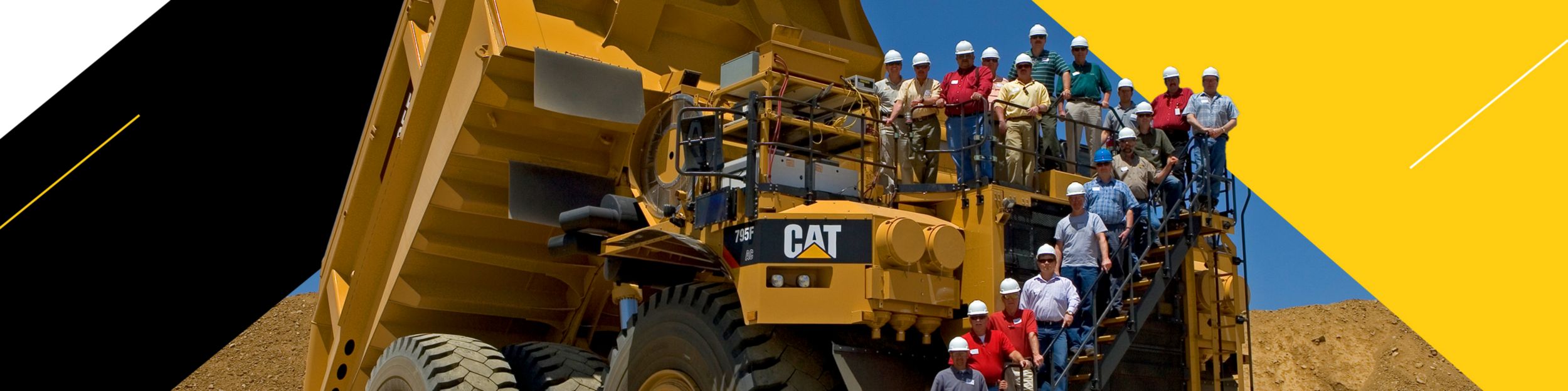 Group photo in front of a 795F Mining machine