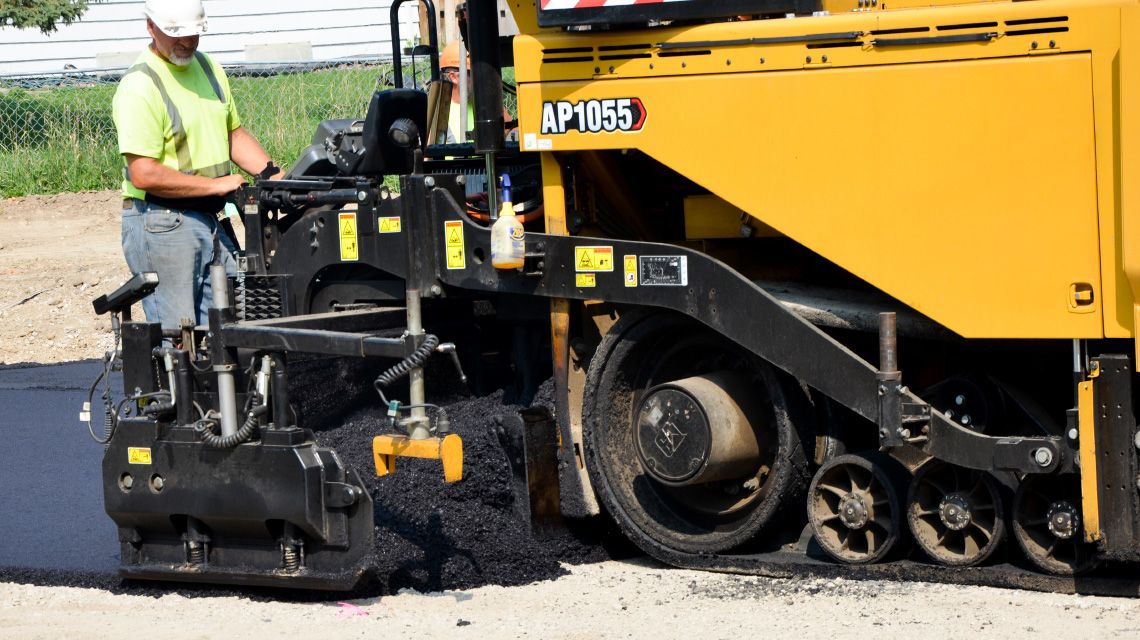 construction professional operating road construction equipment