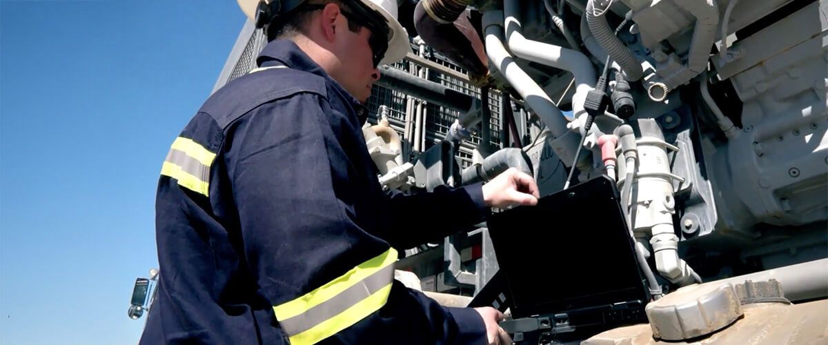 Cat technician working on a machine