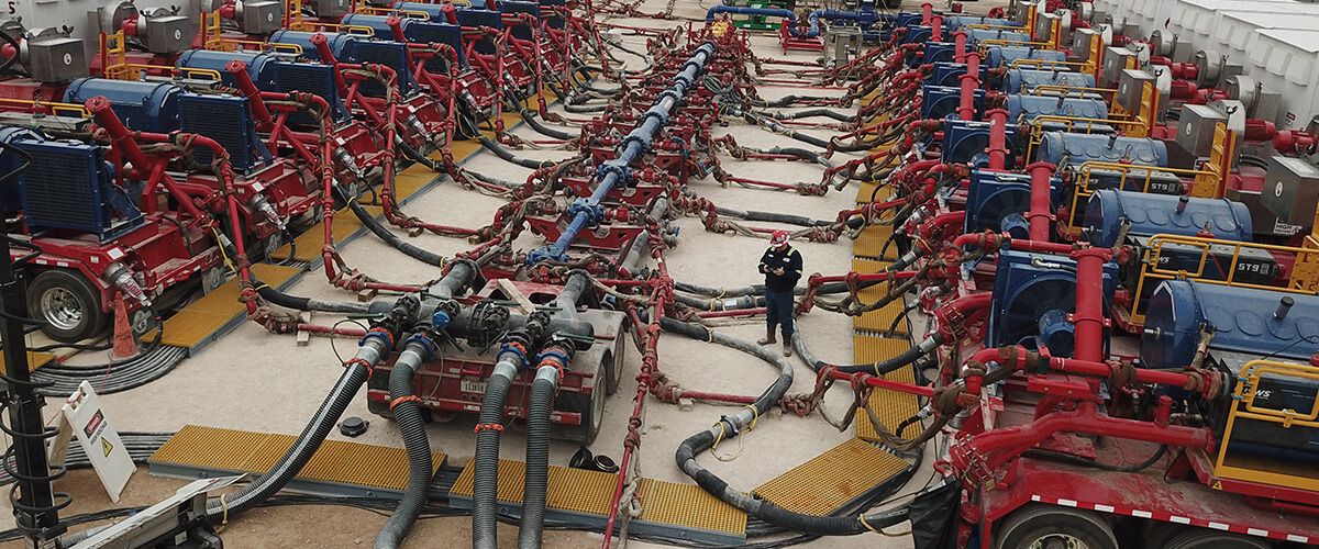 Large Caterpillar Gas Mechanical System with man standing in center on a phone