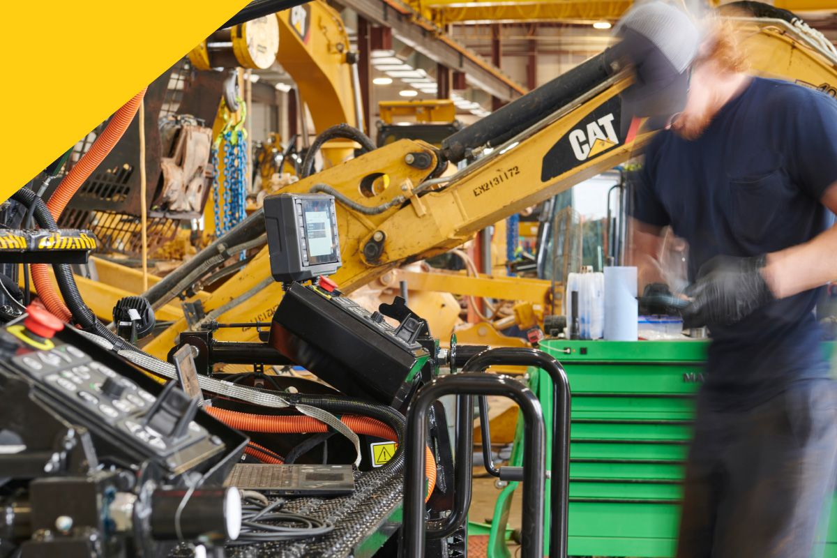 construction professional in warehouse inspecting Cat machine