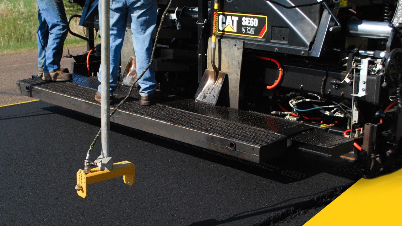 Paving machine being refilled with pavement material