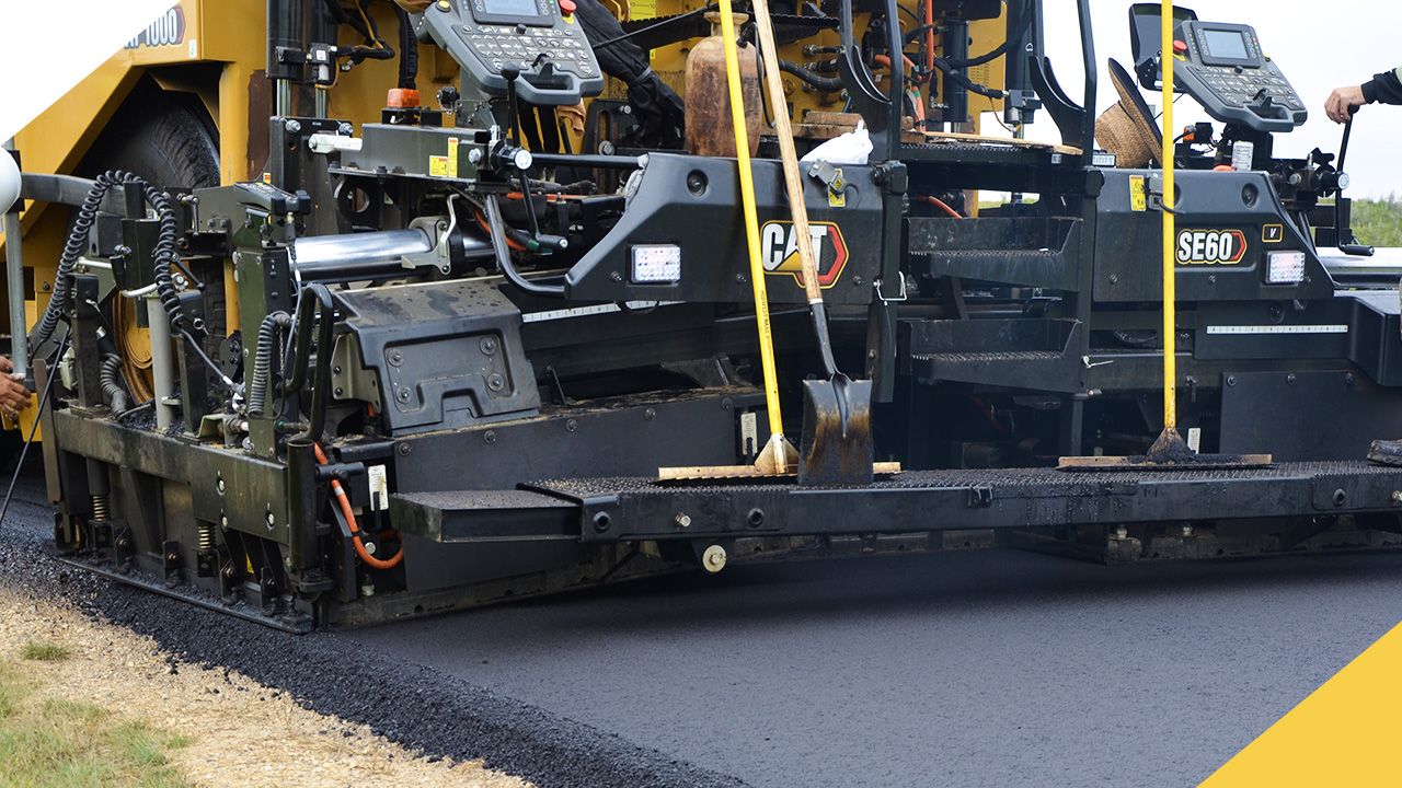 a paving machine laying out some fresh asphalt