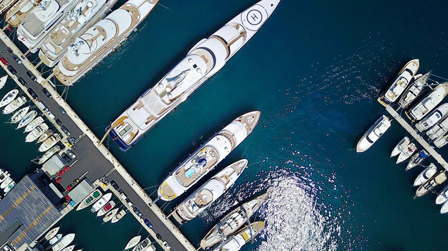Aerial view of different sized yachts and boats at berth in a marina