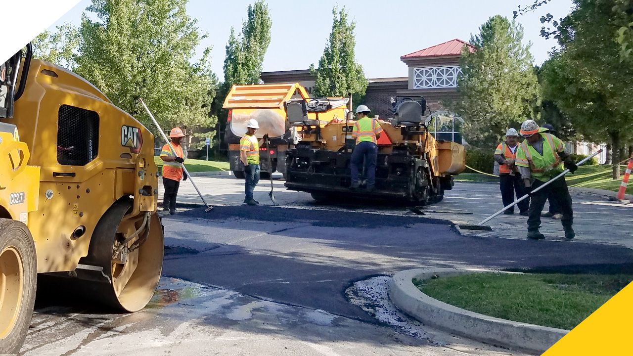 construction professional assisting a paving machine
