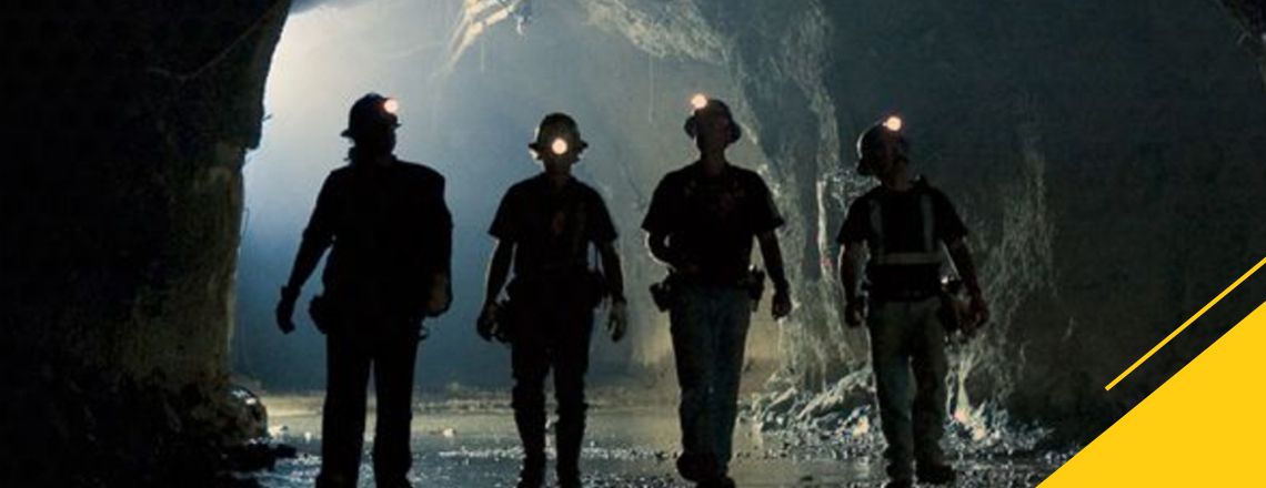 Silhouette of workers in an underground minesite