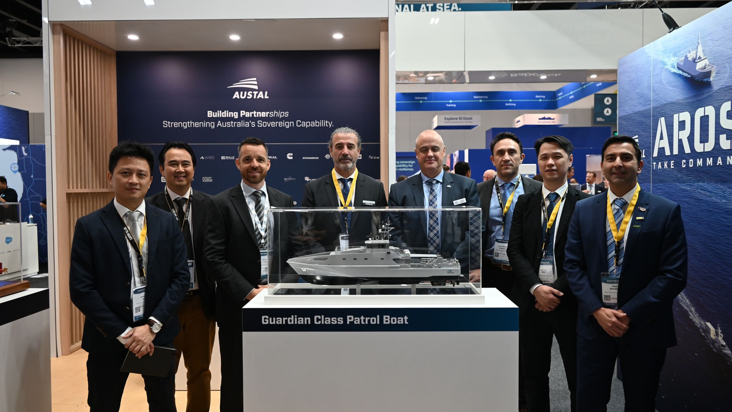 Austal and Caterpillar Marine Management signing GVA - group Image next to vessel model