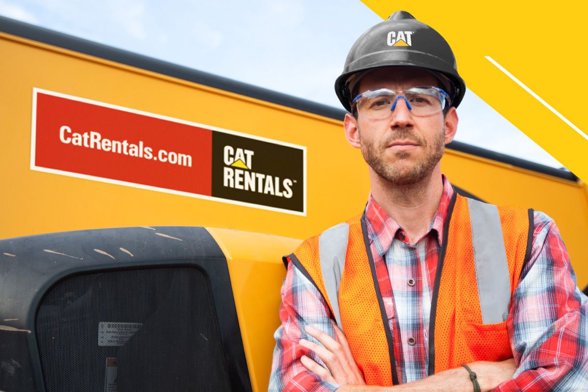 construction professional wearing a Cat hardhat with a Cat Rentals store in the background