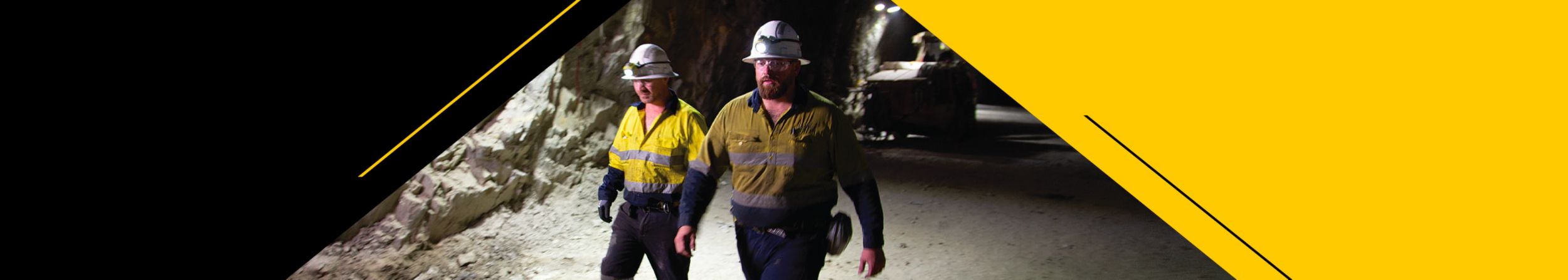 Two men walking in an underground mine