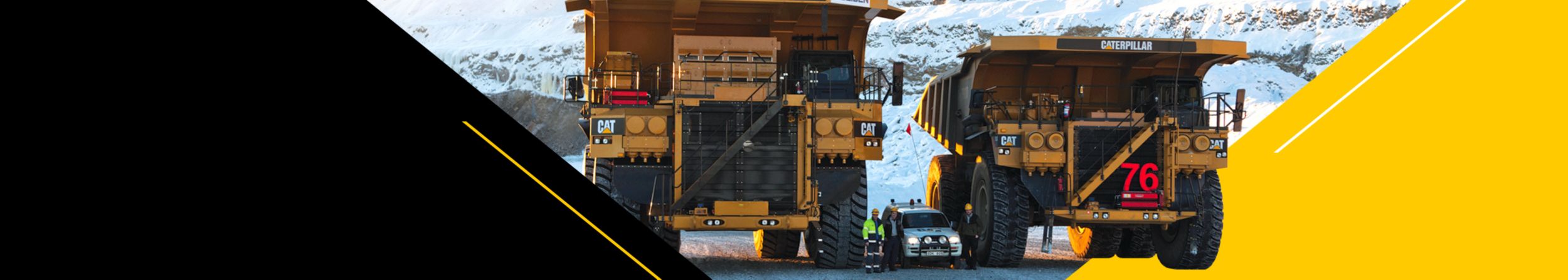 Light vehicle driving between two mining trucks