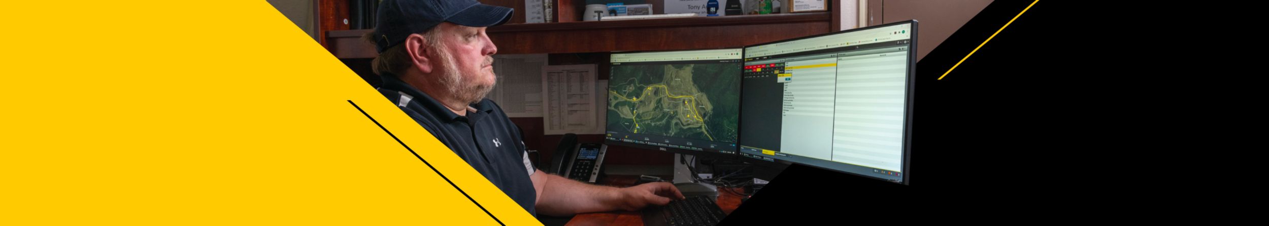 Man looking at mine site data on a computer screen