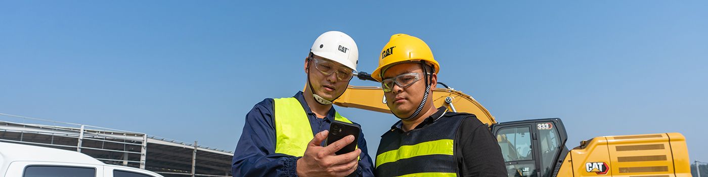 workers on a job site using a phone
